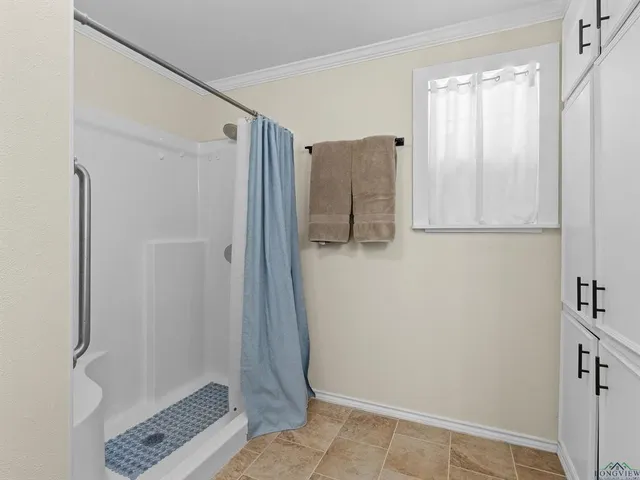 a bathroom with a shower and a sink