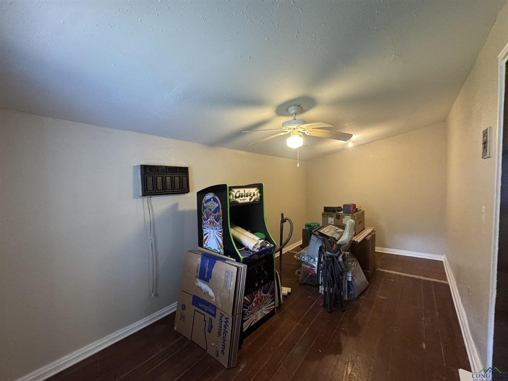 6006 Highway 315 Carthage, TX 75633 - Photo 3 of 35 a view of a room with wooden floor and gym equipment