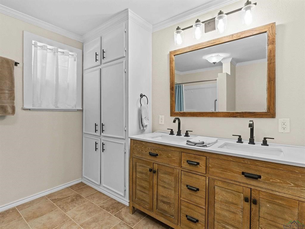 6006 Highway 315 Carthage, TX 75633 - Photo 8 of 35 a bathroom with a double vanity sink and mirror