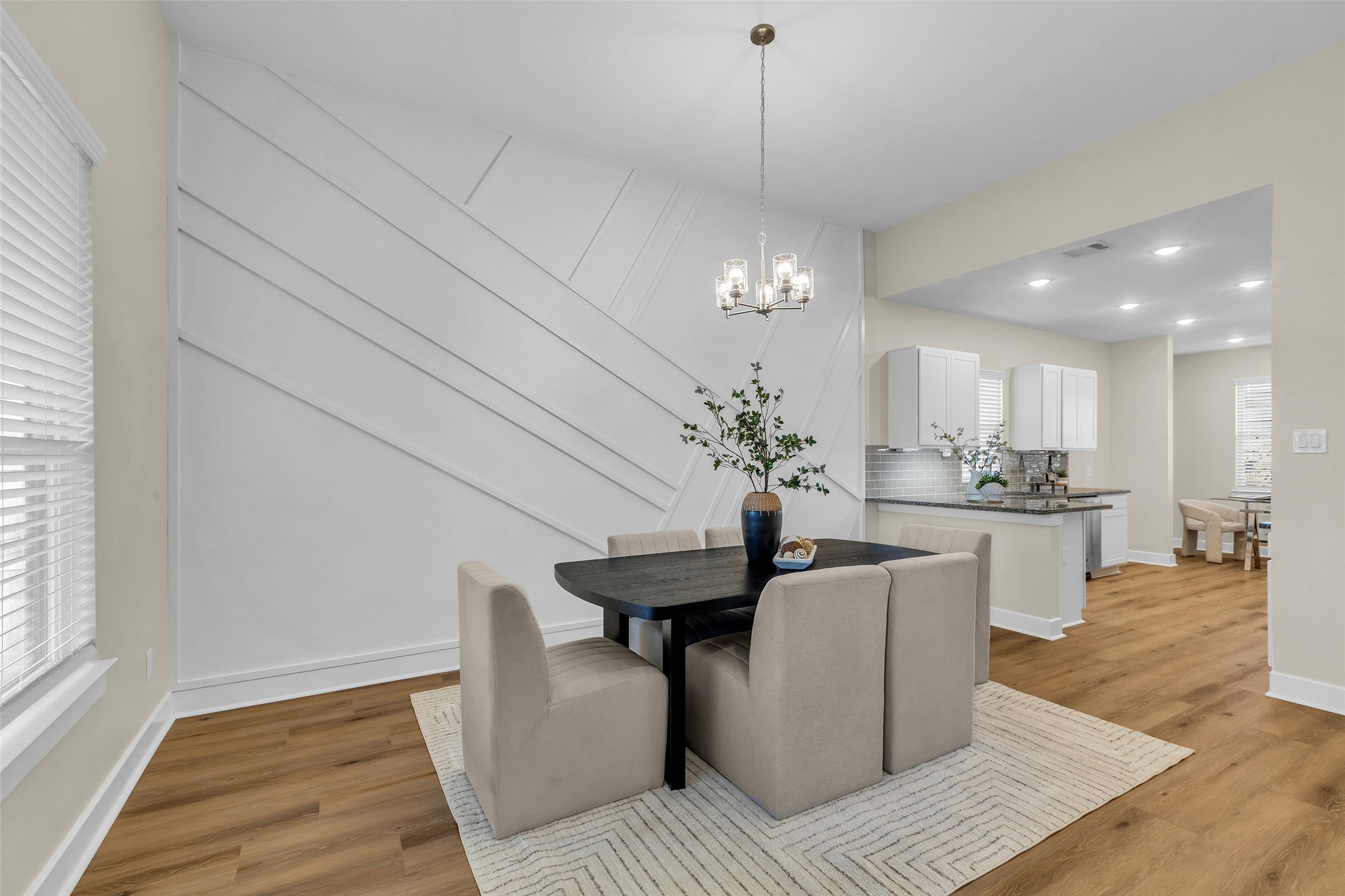 12341 North Chestnut Hills Road Conroe, TX 77303 - Photo 14 of 43 The dining area features a striking wood accent wall, adding warmth and texture to the space.