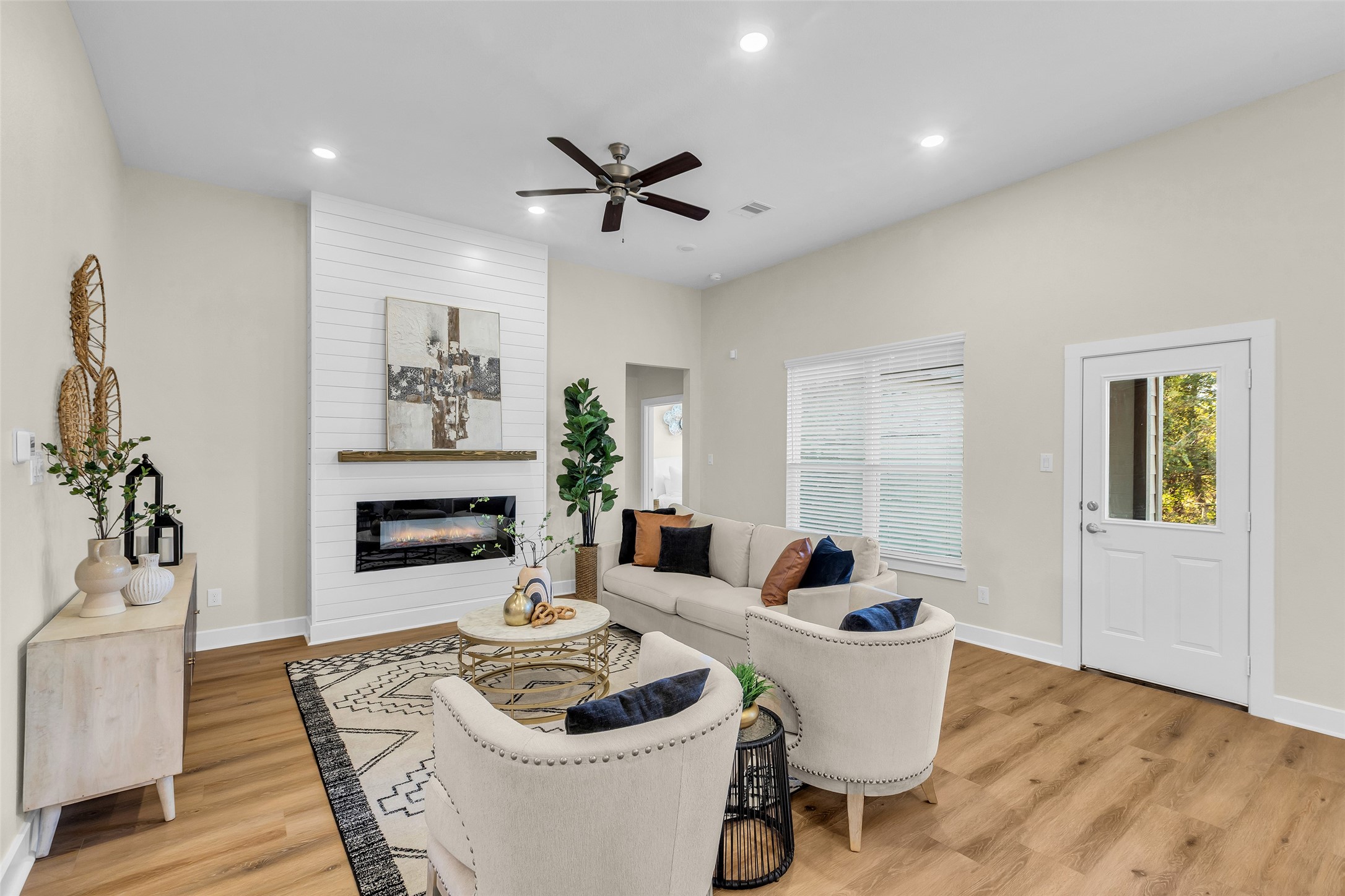 12341 North Chestnut Hills Road Conroe, TX 77303 - Photo 17 of 43 Gather in the cozy living room featuring a modern fireplace that blends comfort with clean, stylish design.