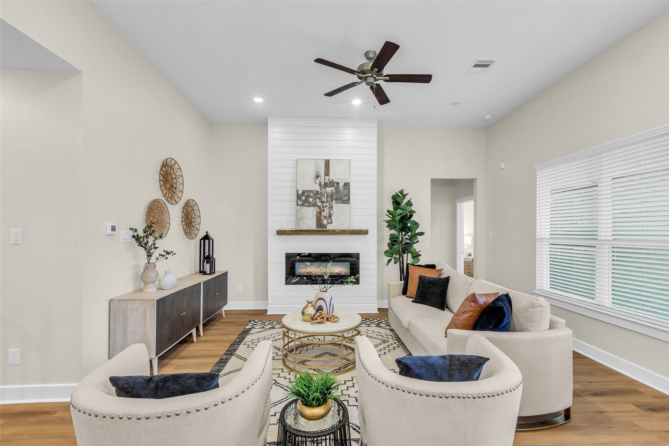12341 North Chestnut Hills Road Conroe, TX 77303 - Photo 18 of 43 This spacious living area is bathed in natural light, highlighting the home’s elegant finishes and inviting ambiance.