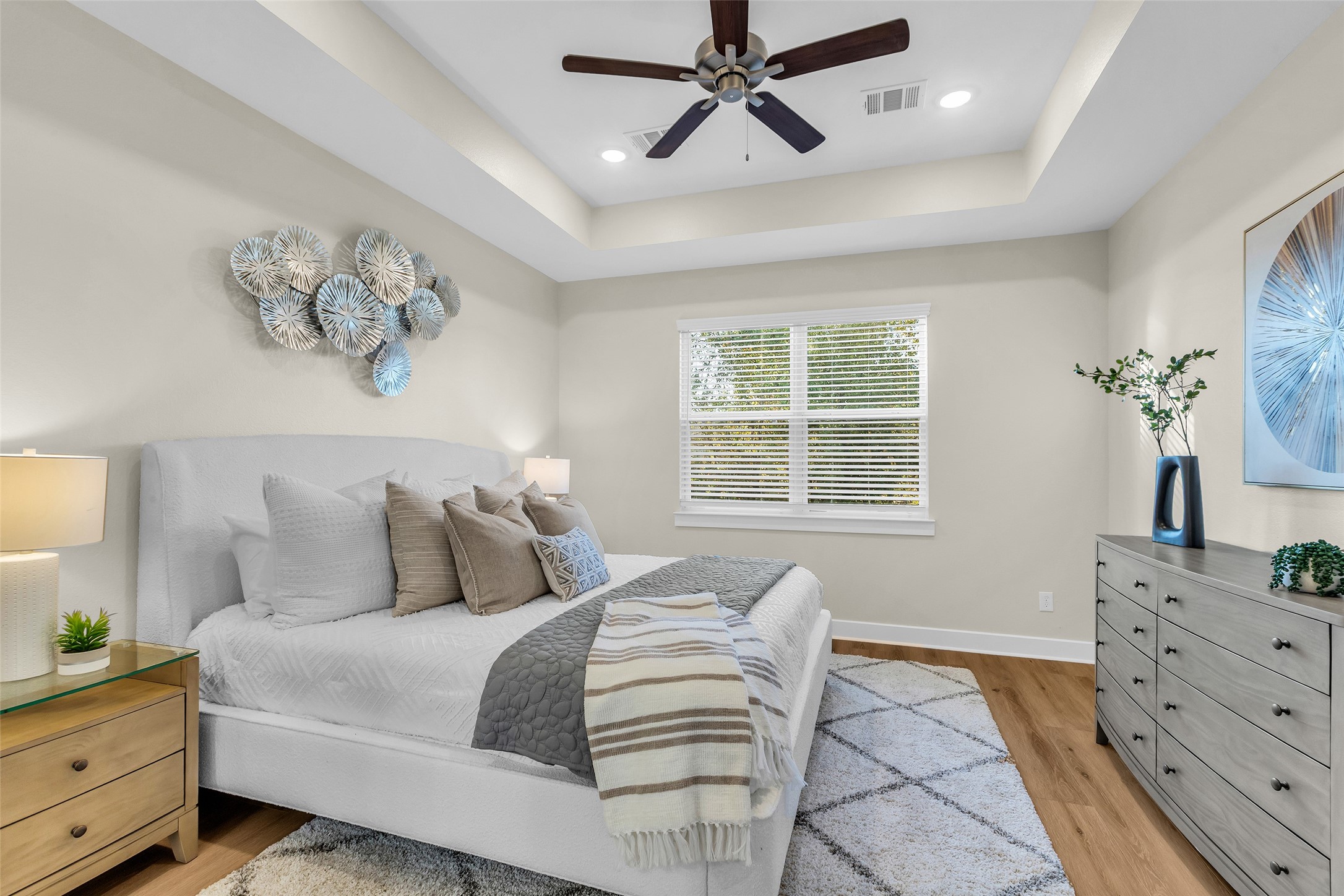 12341 North Chestnut Hills Road Conroe, TX 77303 - Photo 23 of 43 This spacious primary bedroom, set apart from the living room, boasts tray ceilings and plenty of room to create a relaxing retreat.