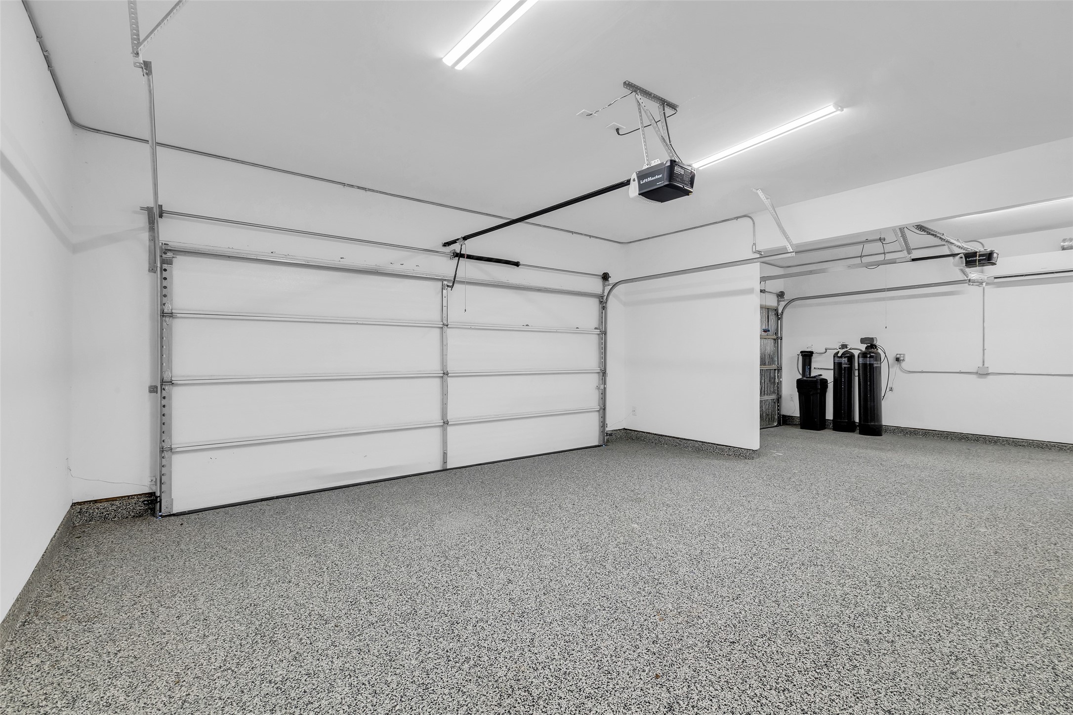 12341 North Chestnut Hills Road Conroe, TX 77303 - Photo 39 of 43 3-car garage with epoxy floors and a mini-split unit.