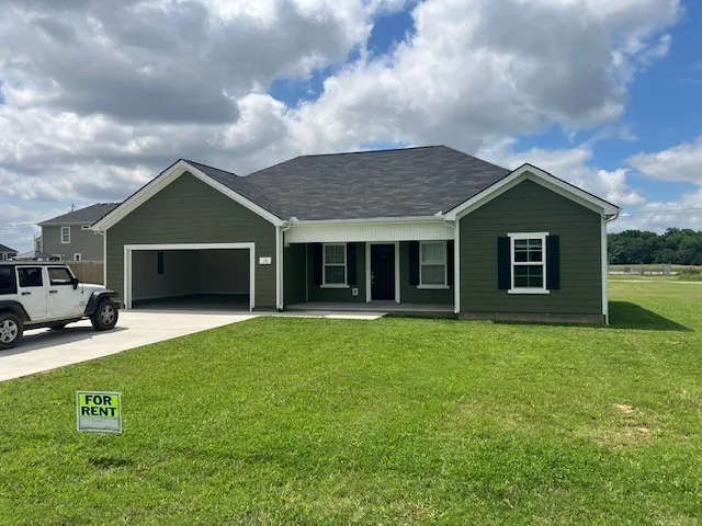 a front view of a house with a garden and yard
