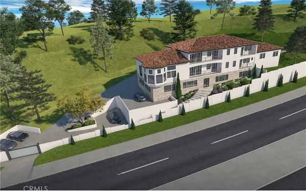 an aerial view of a house with a yard