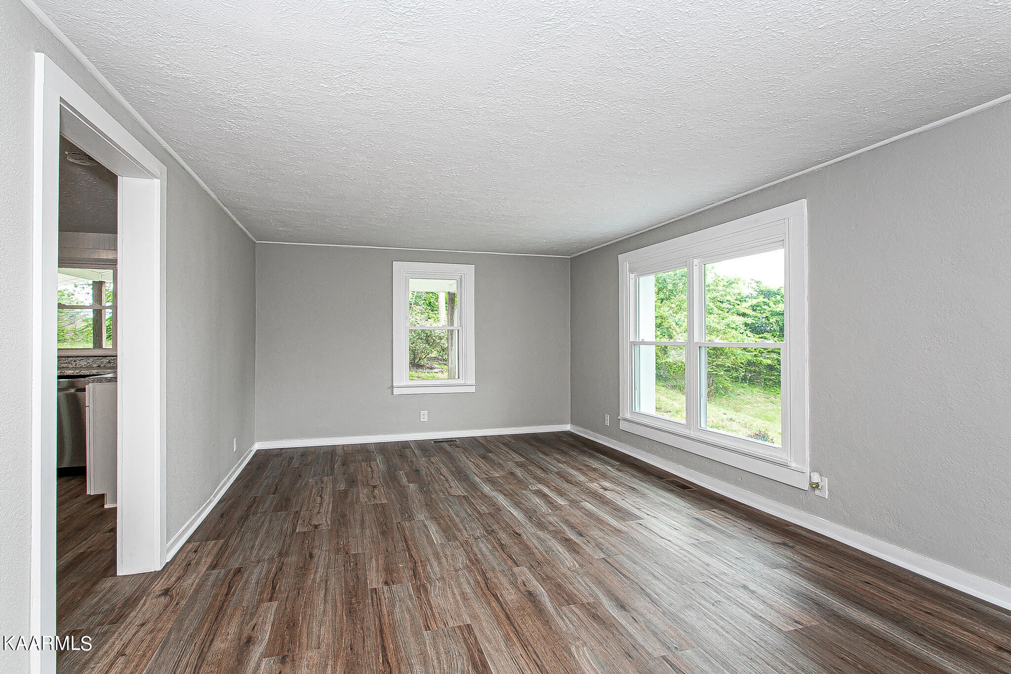 207 Bethel Road Clinton, TN 37716 - Photo 3 of 36 a view of an empty room with wooden floor and a window