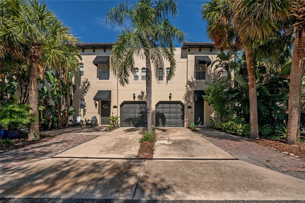 a view of a house with palm trees