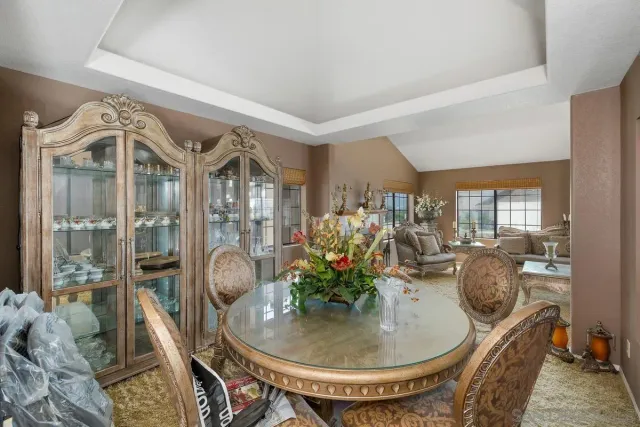 a view of a dining room with furniture and chandelier
