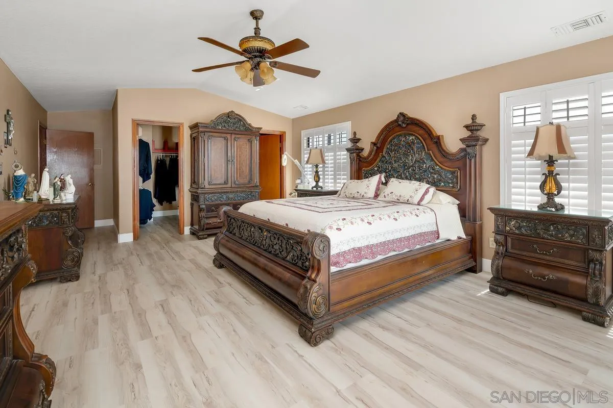 14650 Alkosh Road Jamul, CA 91935 - Photo 16 of 35 a bedroom with a bed chandelier and a window