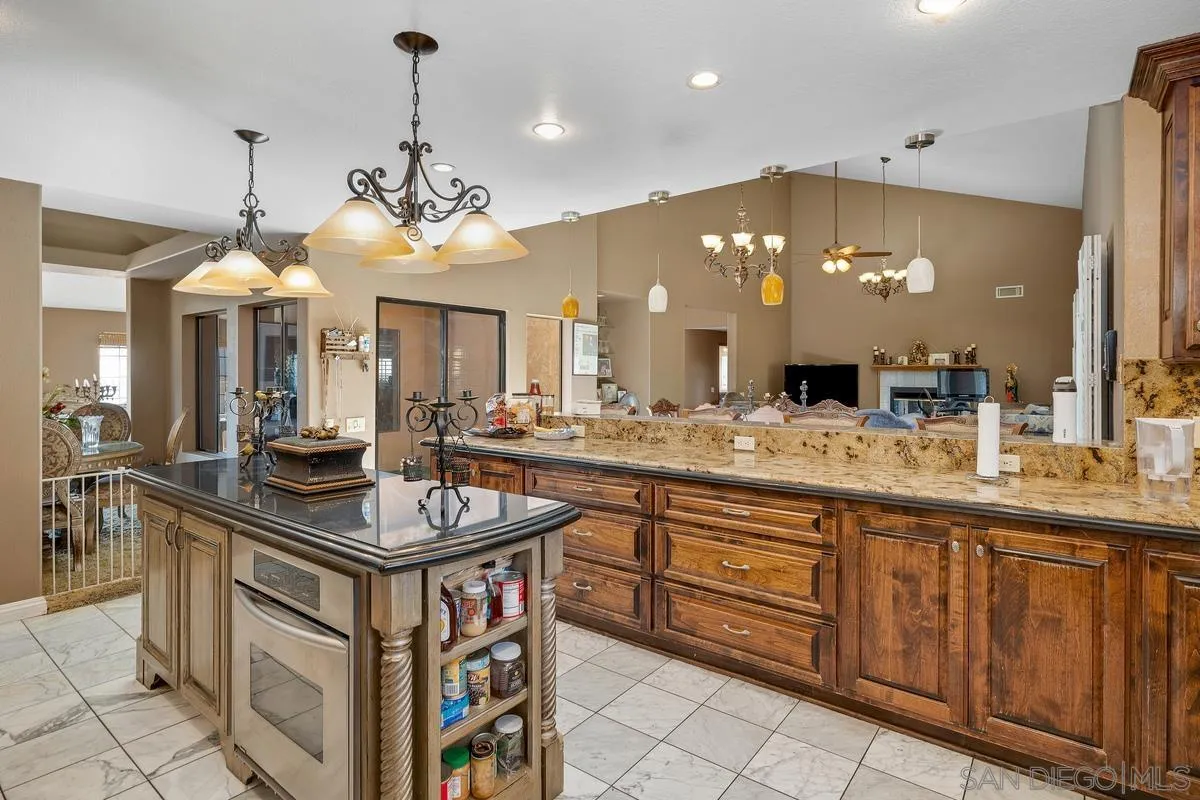 14650 Alkosh Road Jamul, CA 91935 - Photo 4 of 35 a kitchen with a sink and a chandelier
