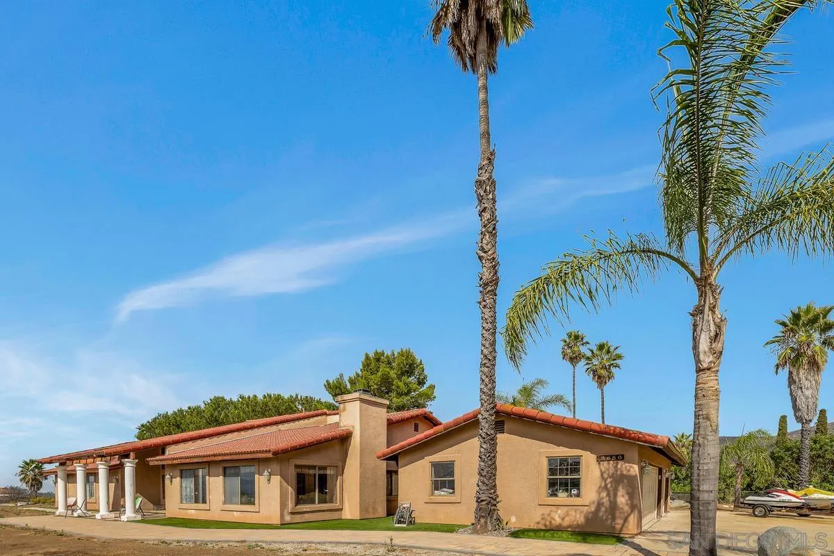 14650 Alkosh Road Jamul, CA 91935 - Photo 7 of 35 a view of a house with a palm tree next to a road