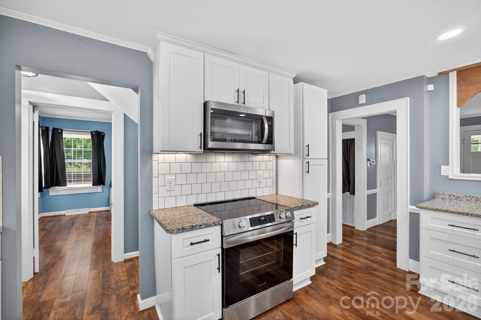 1016 Raney Street Salisbury, NC 28146 - Photo 12 of 45 a kitchen with stainless steel appliances white cabinets and stove