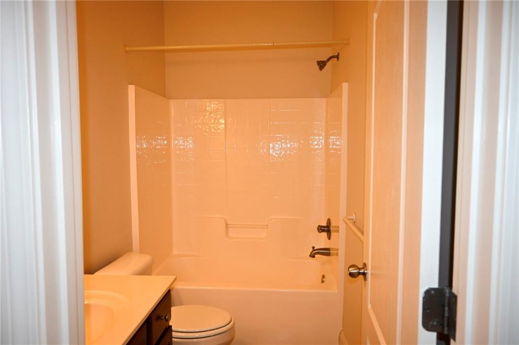 25 Kaktovic Court Southeast Grayson, GA 30017 - Photo 22 of 56 a bathroom with a shower curtain