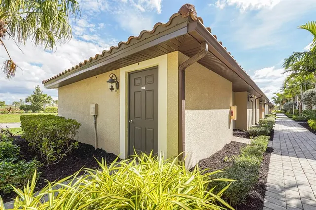 a view of a patio with a table and chairs under an umbrella