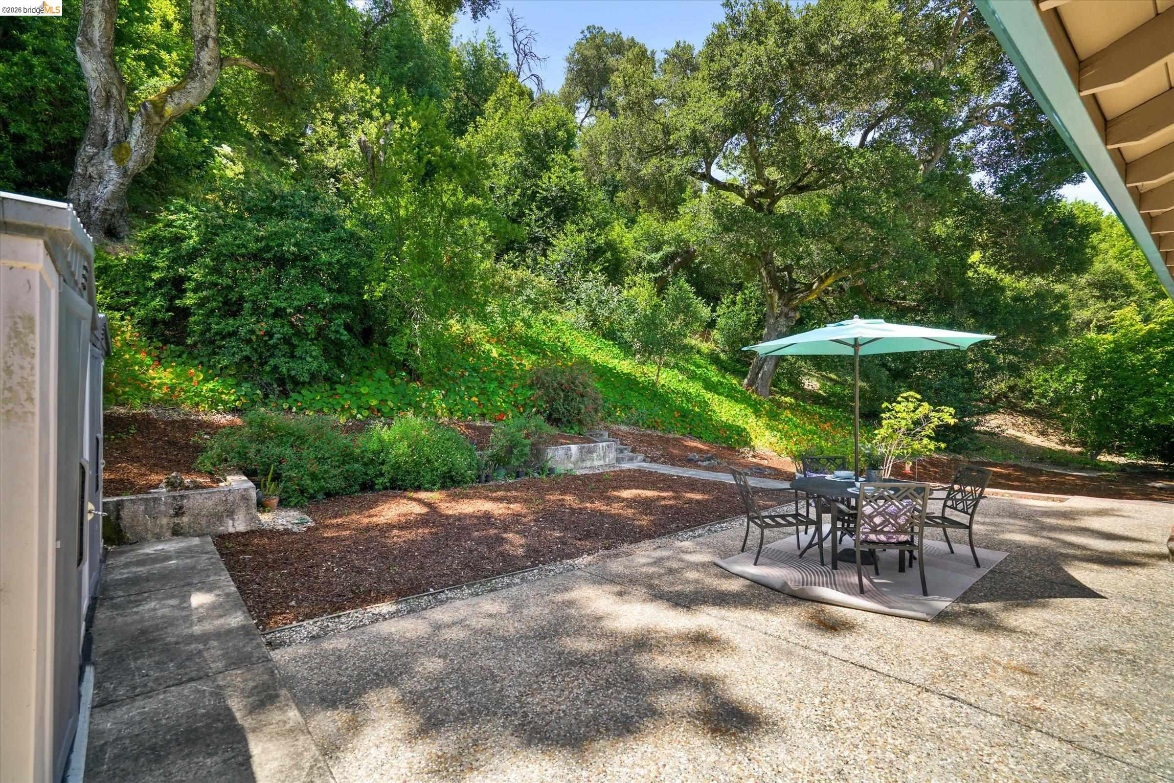 2826 Wright Avenue Pinole, CA 94564 - Photo 50 of 70 Expansive exposed aggregate patio with surrounding mature trees and lush landscaping
