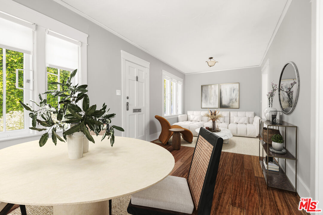 a view of a dining room with furniture window and wooden floor