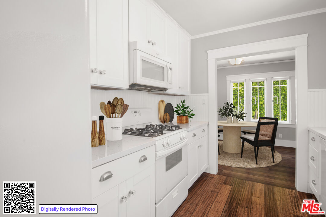 1047 9th Street Santa Monica, CA 90403 - Photo 5 of 20 a white kitchen with a stove a sink wooden floor and a dining table