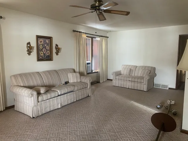 a living room with furniture and a lamp