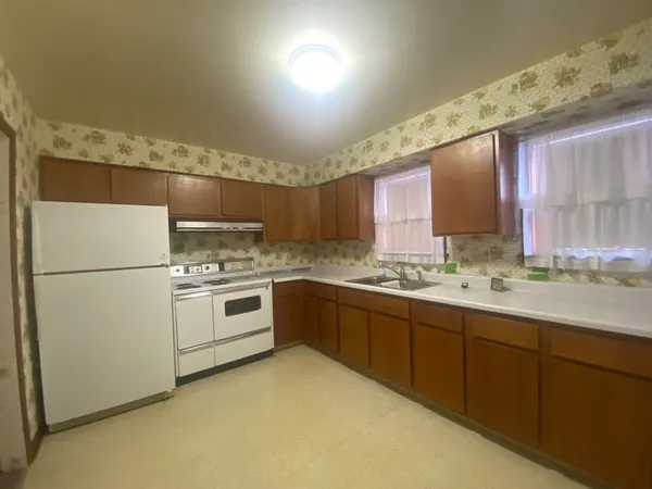 a kitchen with a sink appliances and cabinets