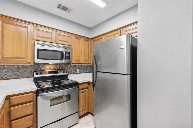 a kitchen with a refrigerator stove and microwave