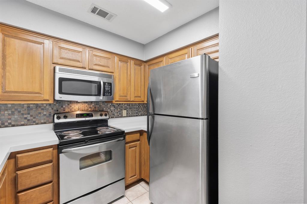 1712 Baird Farm Circle, Unit 2101 Arlington, TX 76006 - Photo 16 of 30 a kitchen with a refrigerator stove and microwave