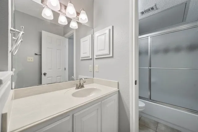 a bathroom with a sink vanity and a mirror