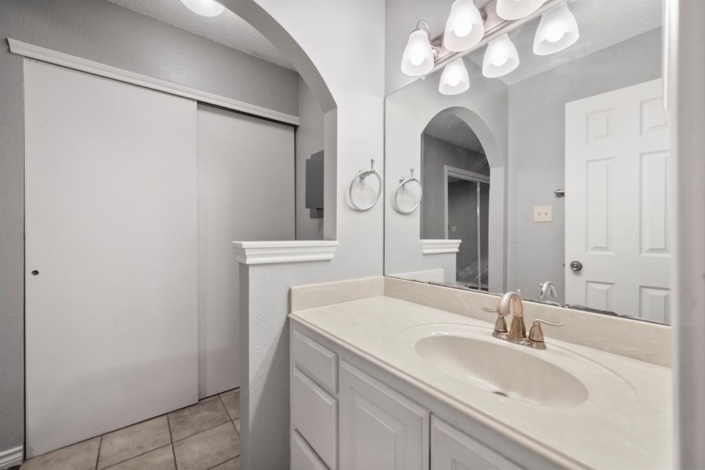 1712 Baird Farm Circle, Unit 2101 Arlington, TX 76006 - Photo 24 of 30 a bathroom with a sink and a mirror