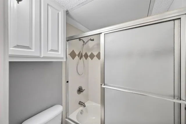 a bathroom with a shower and a toilet