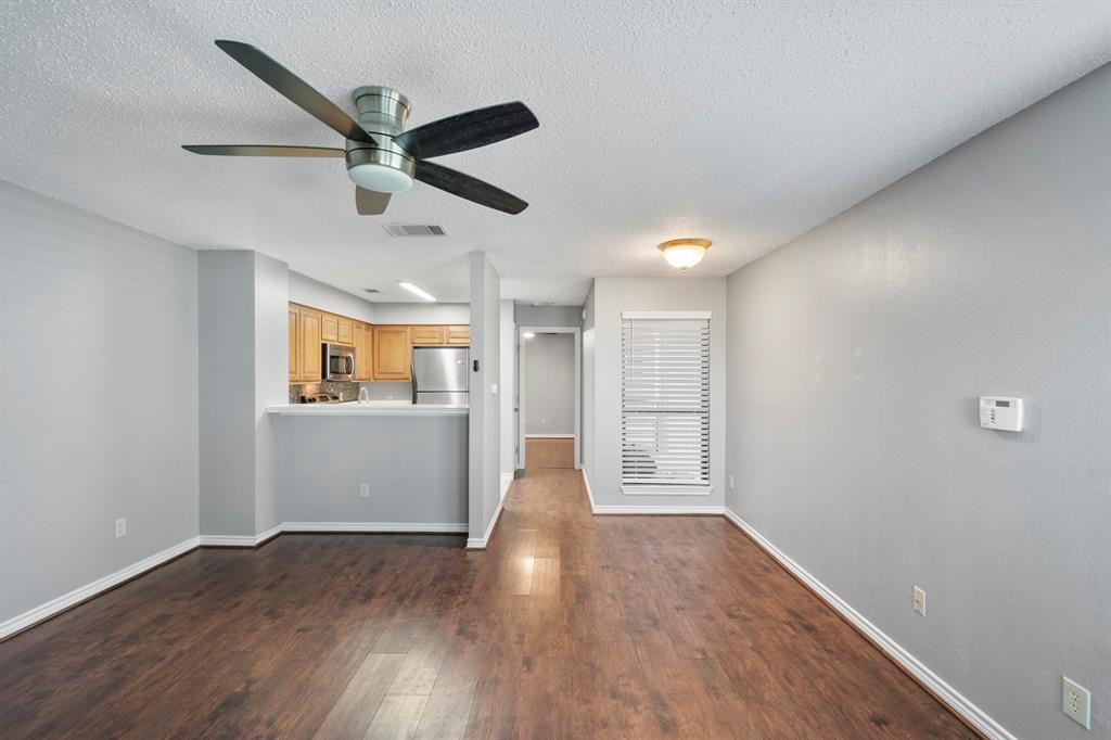 1712 Baird Farm Circle, Unit 2101 Arlington, TX 76006 - Photo 9 of 30 a view of empty room with wooden floor and ceiling fan