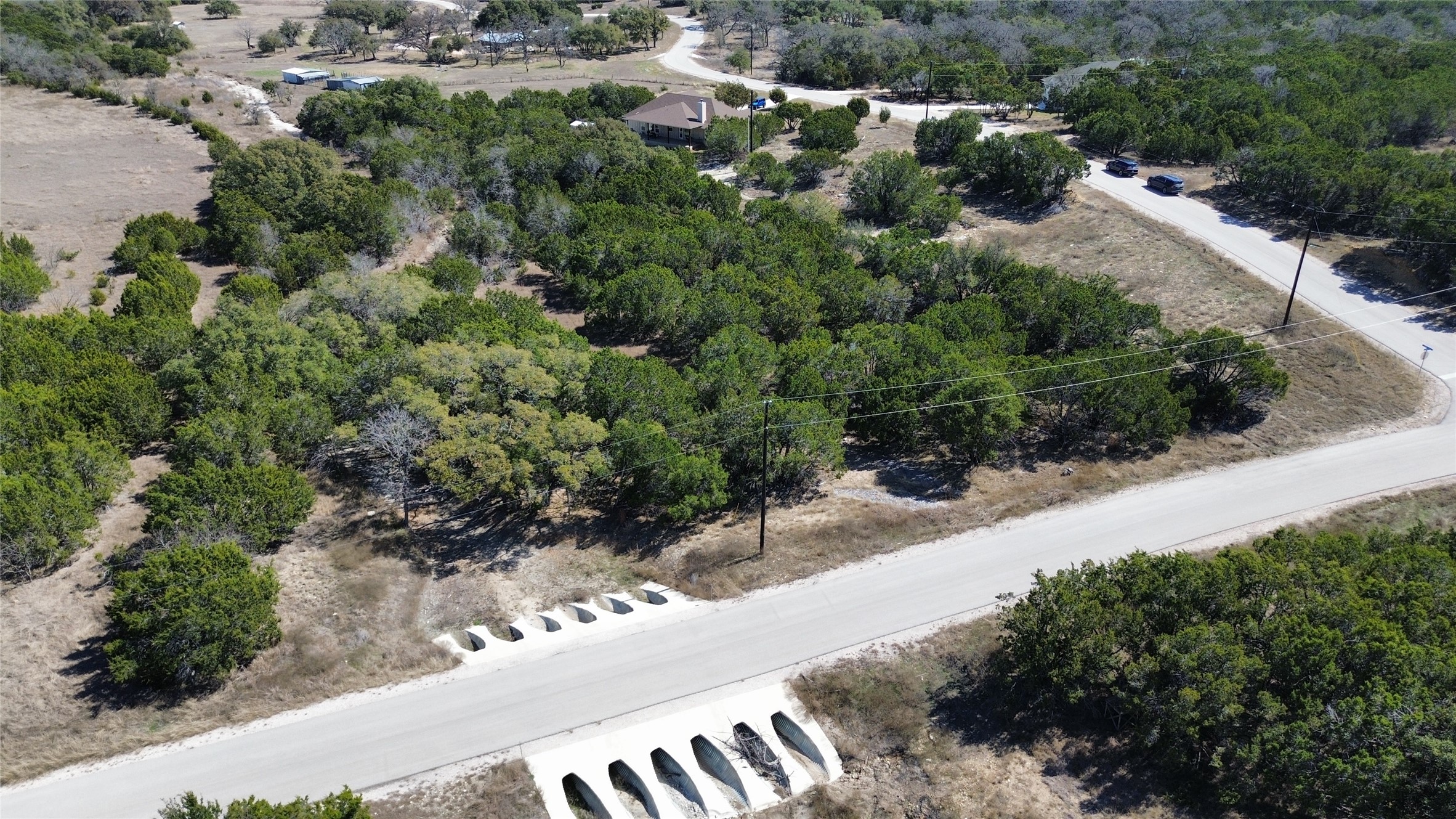 Lot 32 Garner Ranch Road Bertram, TX 78605 - Photo 7 of 8 an aerial view of a house with a yard and greenery