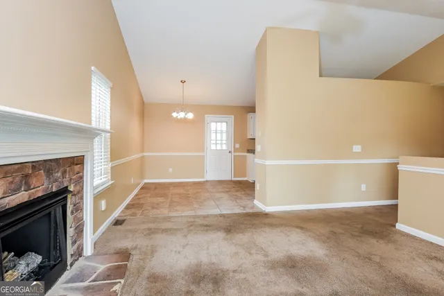 a view of a livingroom with a fireplace and a rug