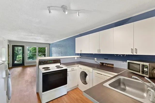 a kitchen that has a sink and a stove