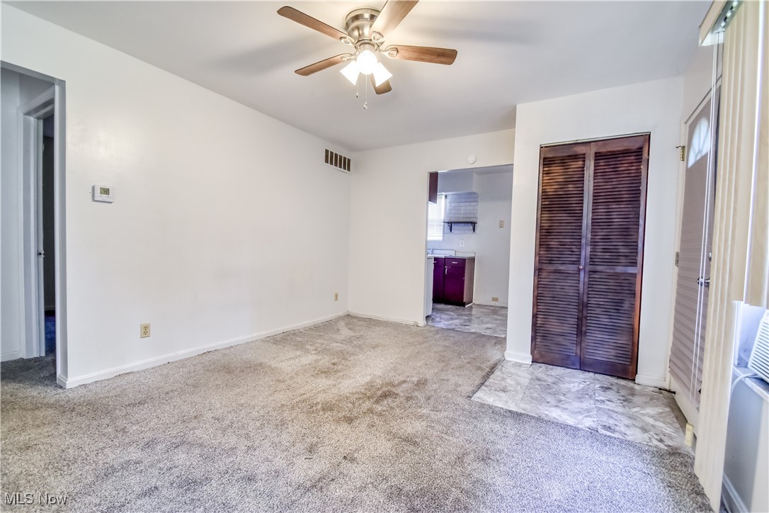 4380 Wyatt Road Cleveland, OH 44128 - Photo 18 of 26 Unfurnished bedroom featuring a closet, carpet floors, ceiling fan, and ensuite bath