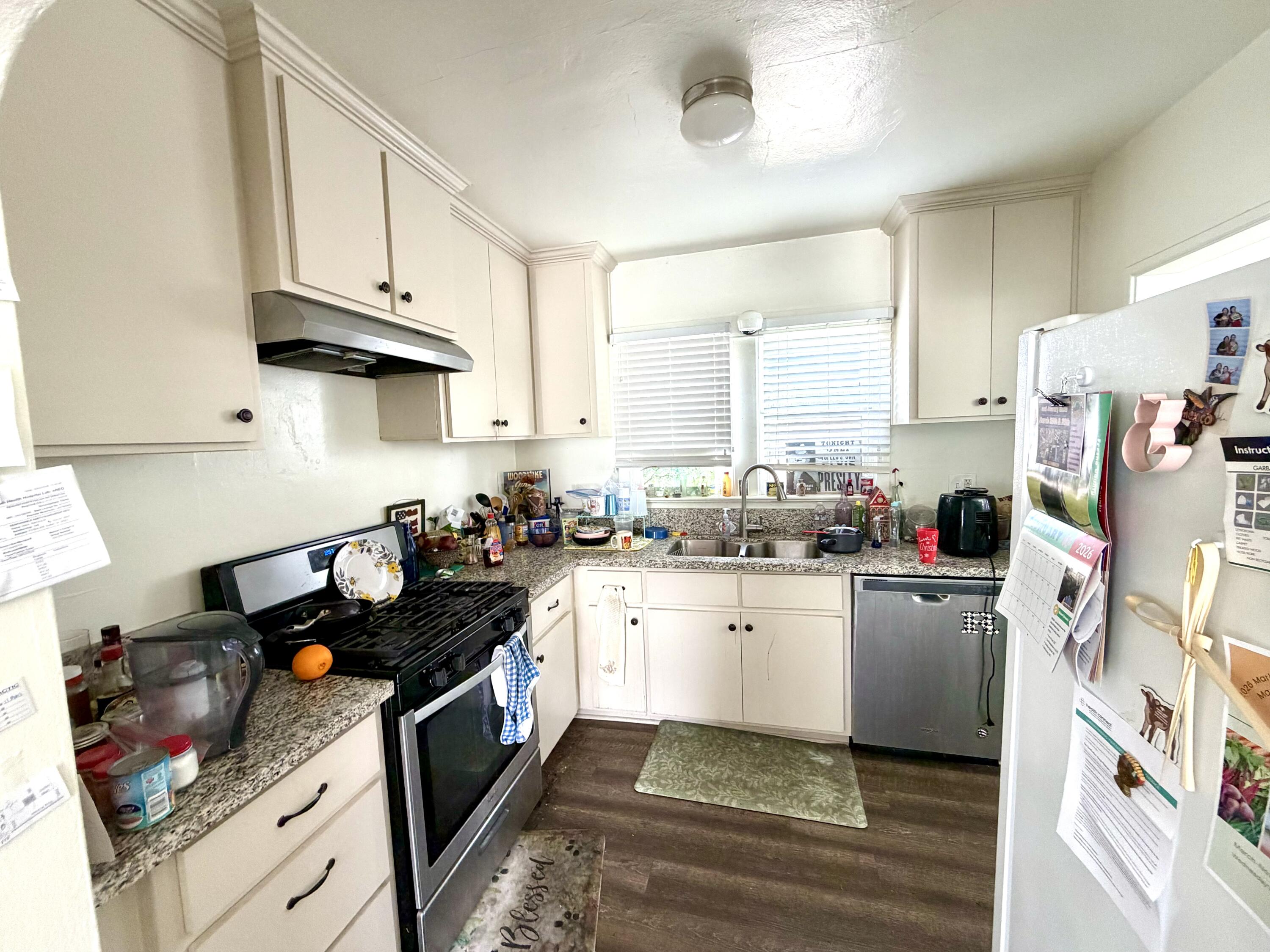 200 North B Street Exeter, CA 93221 - Photo 13 of 20 a kitchen with stainless steel appliances granite countertop a stove and a sink