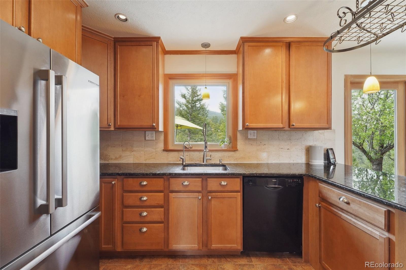 855 Kelly Road West Boulder, CO 80302 - Photo 11 of 40 a kitchen with a sink a counter top space cabinets and stainless steel appliances