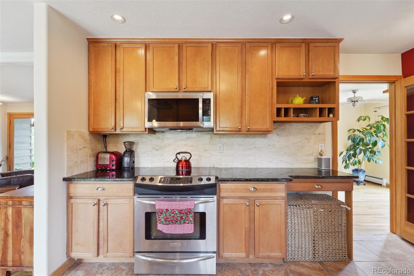 855 Kelly Road West Boulder, CO 80302 - Photo 12 of 40 a kitchen with stainless steel appliances granite countertop a stove a sink and a microwave