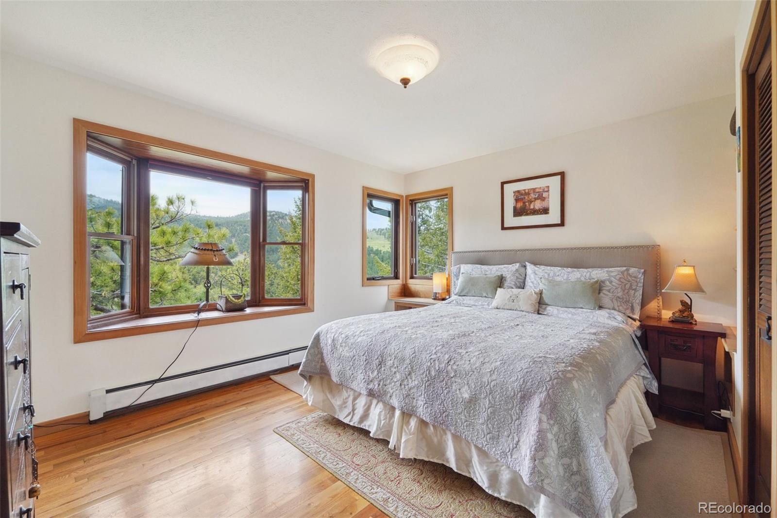 855 Kelly Road West Boulder, CO 80302 - Photo 16 of 40 a spacious bedroom with a bed and a large window
