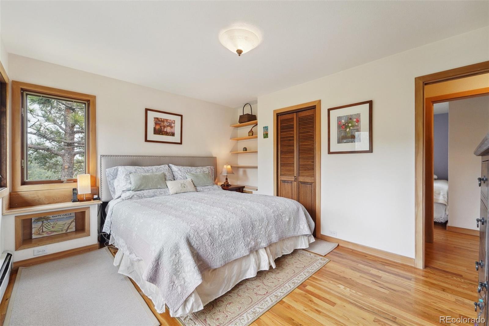 855 Kelly Road West Boulder, CO 80302 - Photo 17 of 40 a bedroom with a large bed and a window