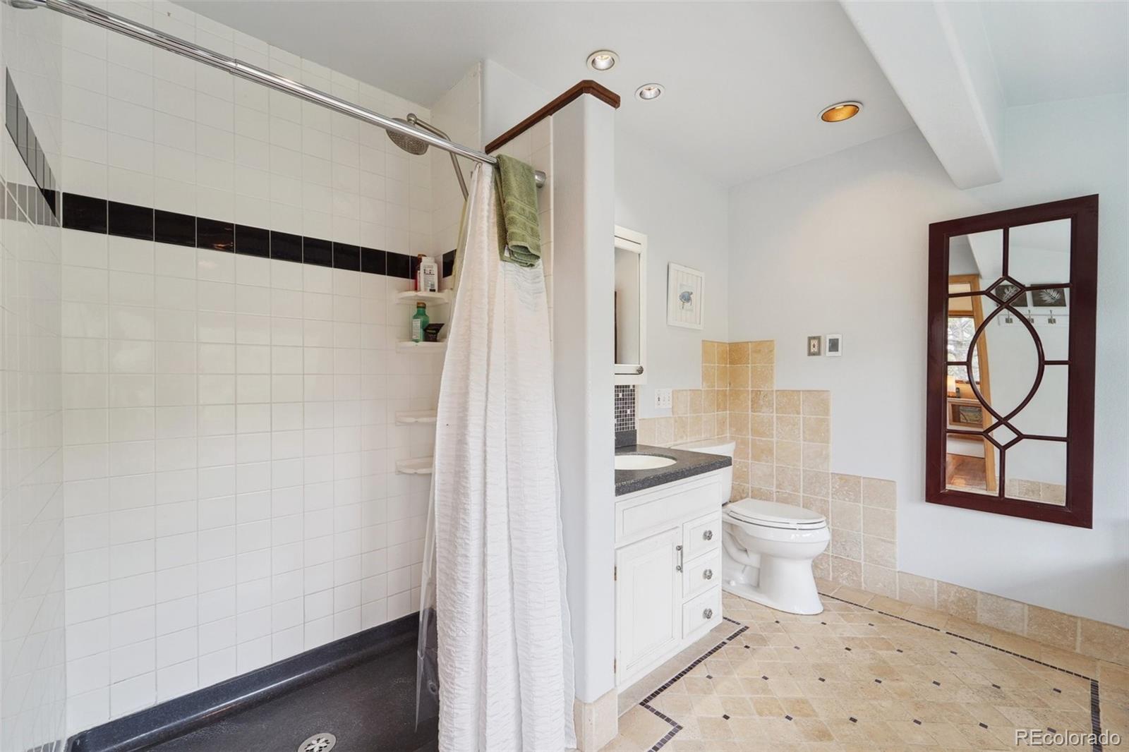 855 Kelly Road West Boulder, CO 80302 - Photo 19 of 40 a bathroom with a toilet sink and a shower