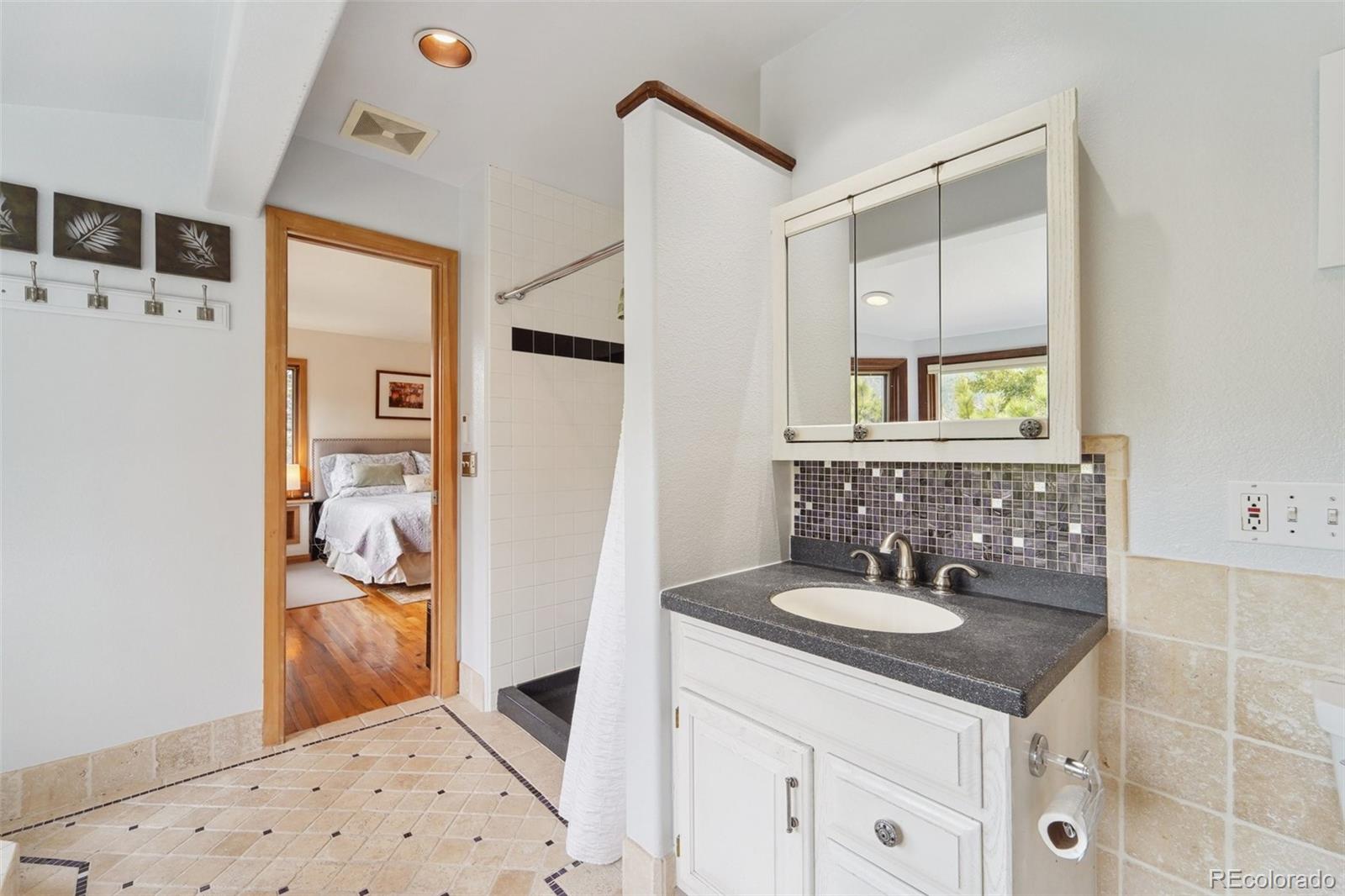 855 Kelly Road West Boulder, CO 80302 - Photo 20 of 40 a bathroom with a sink a vanity and a mirror