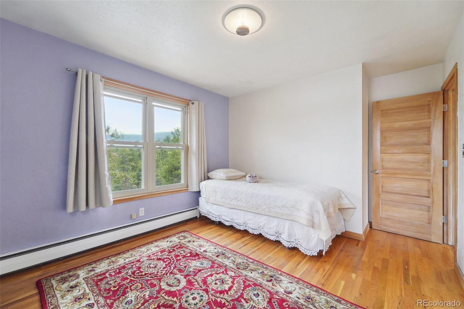 855 Kelly Road West Boulder, CO 80302 - Photo 22 of 40 a bedroom with a bed and a window