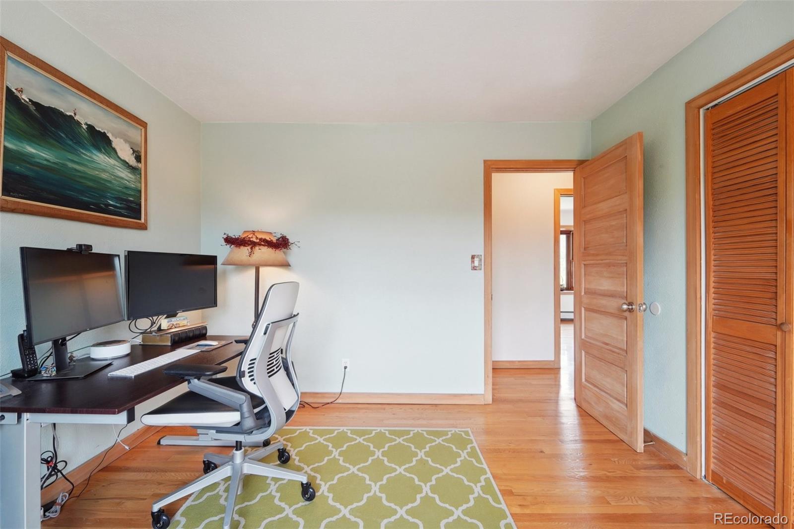 855 Kelly Road West Boulder, CO 80302 - Photo 27 of 40 a view of a workspace with furniture and wooden floor