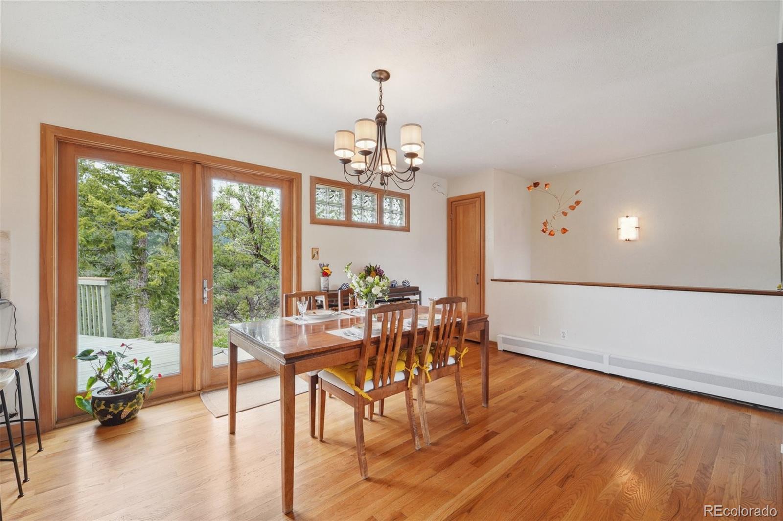 855 Kelly Road West Boulder, CO 80302 - Photo 6 of 40 a view of a dining room with furniture window and wooden floor