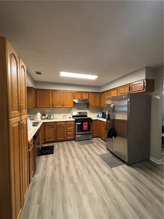 4949 Penscot Way Stone Mountain, GA 30088 - Photo 8 of 40 a kitchen with stainless steel appliances granite countertop a refrigerator a sink and a stove