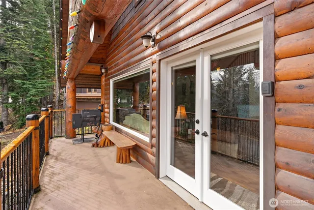 a porch with outdoor seating and a glass door