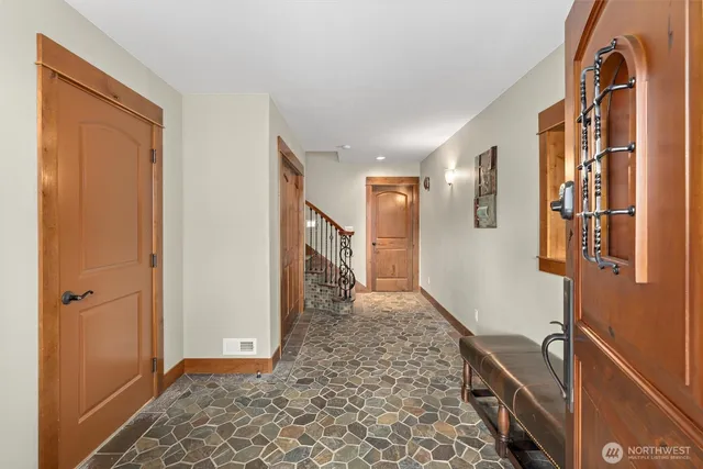 a view of hallway with a door and windows
