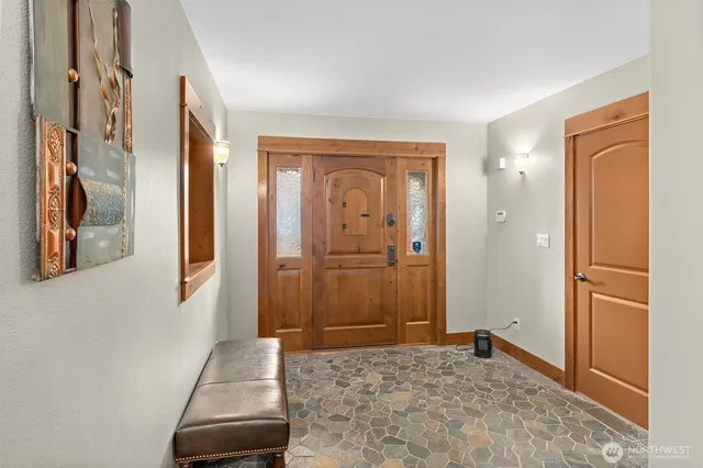 a view of a hallway with wooden floor and a livingroom