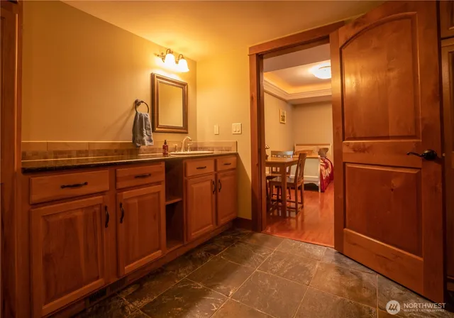 a view of a bathroom with a mirror and a sink