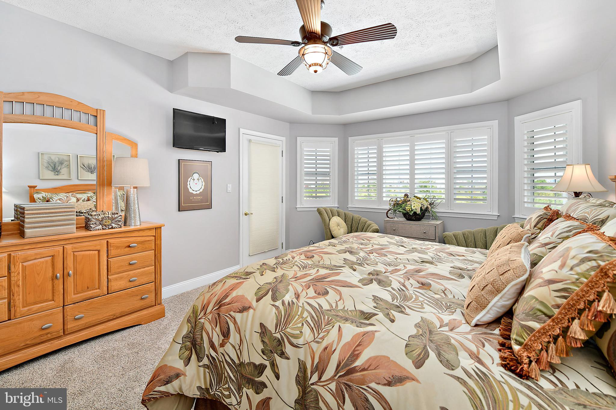 9742 Golf Course Road, Unit 202 Ocean City, MD 21842 - Photo 22 of 36 Plantation Shutters and Door to the Balcony